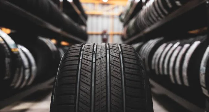 A large storage room with many tyres stacked in a warehouset